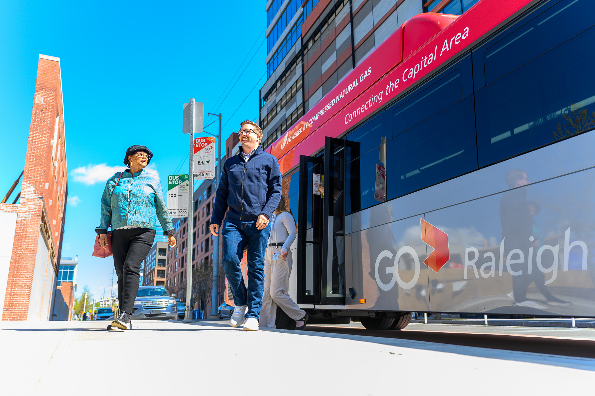Riders exiting the GoRaleigh bus in downtown Raleigh in the warehouse district